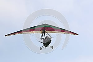 Ultralight airplane flying in a blue sky