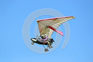 Ultralight airplane flying in a blue sky