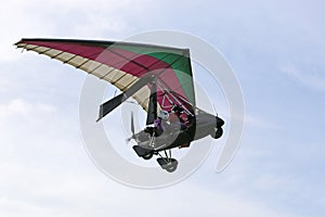 Ultralight airplane flying in a blue sky