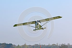 Ultralight airplane flying in a blue sky