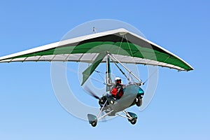 Ultralight airplane flying in a blue sky