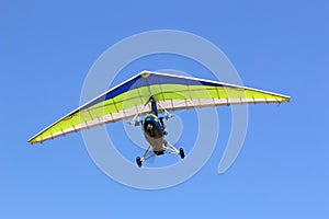 Ultralight airplane flying in a blue sky