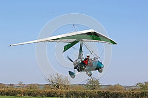 Ultralight airplane flying in a blue sky