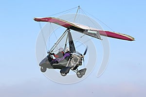 Ultralight airplane flying in a blue sky