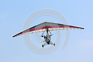 Ultralight airplane flying in a blue sky