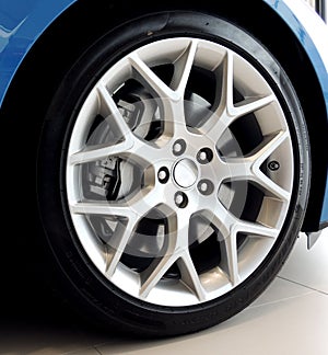 Ultralight alloy wheel mounted on a sports car closeup stock photo