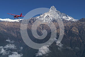 Ultralight plane flies over Pokhara and Machapuchare