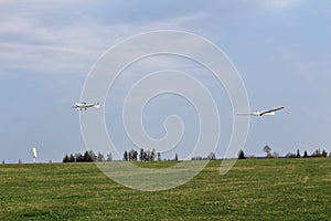 Ultralight plane pull glider to sky with wind indicator