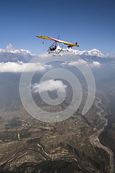 Ultralight plane and trike fly and Machapuchare summit