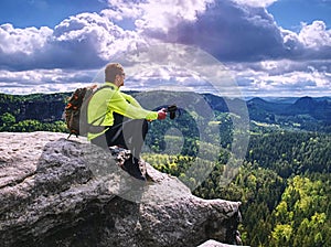 Ultralight runner on trail with tracking poles. Tired sitting tourist