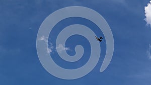 Ultralight small propeller-driven private jet flying in the sky with clouds over the airfield. Rear view of a turboprop aircraft t