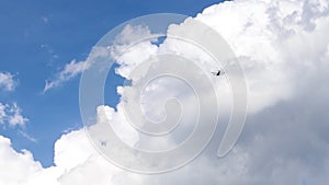 Ultralight small propeller-driven private jet flying in the sky with clouds over the airfield. Rear view of a turboprop aircraft t