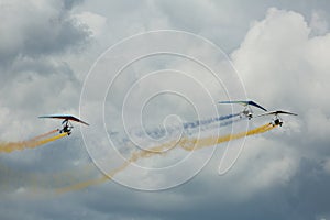 Ultralight trikes performing in sky on air show