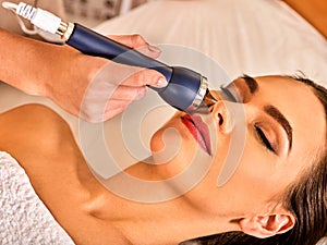 Ultrasonic facial treatment on ultrasound man face machine.