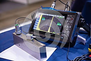 Ultrasonic flaw detector. Ultrasonic testing. Acoustic thickness gauge photo