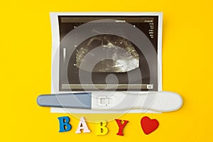 Ultrasonic image and positive pregnancy test and the word `baby