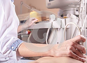 ultrasound diagnostics doctor, conducts a study using a scanner, the patient is a child