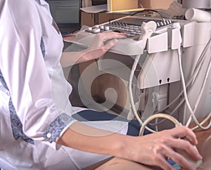 Ultrasound diagnostics doctor, conducts a study using a scanner, the patient is a child