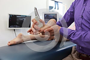 Ultrasound of girl`s foot - diagnosis photo