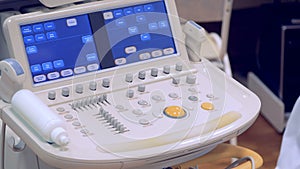 An ultrasound panel is being regulated by a doctor`s hand