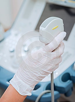 Ultrasound scanner in the hands of a doctor. Diagnostics. Sonography