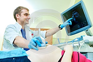 Ultrasound test. Pregnancy. Gynecologist checking fetal life with scanner. photo