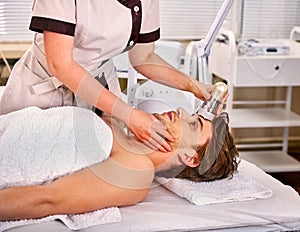 Ultrasound therapy for male skin tightening in beauty spa salon