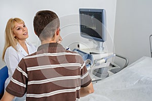 Ultrasunography doctor is explaining to the patientat divice