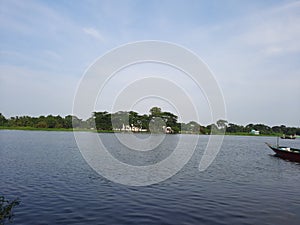 Ultrawide angle shot that present insane nature of rural view.River, boat,sky and trees a perfect symbol of country life.