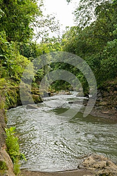 Uma Anyar waterfall, Bali, Indonesia. Jungle, forest, daytime with cloudy sky photo