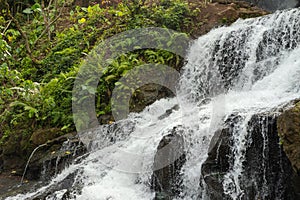 Uma Anyar waterfall, Bali, Indonesia. Jungle, forest, daytime with cloudy sky photo