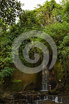 Uma Anyar waterfall, Bali, Indonesia. Jungle, forest, daytime with cloudy sky photo