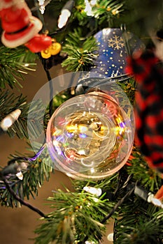 Decoration of a lamp with colorful revolving lights on the Christmas tree photo