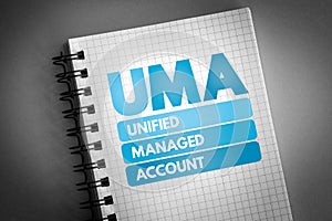 UMA - Unified Managed Account acronym on notepad, business concept background