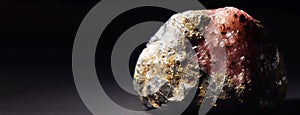 Umbite fossil mineral stone. Geological crystalline fossil. Dark background close-up.