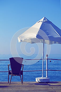 Umbrela and armchair at the sea