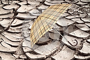 Umbrella on the arid soil from the heat