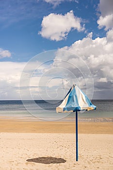 an umbrella on the beach of the tropical island. Vacation relaxation with turquoise sea and blue sky landscape. Summer vacation