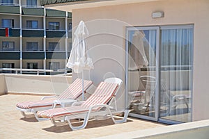 Umbrella and chaise lounges