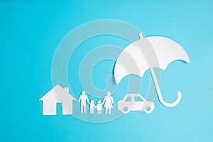 Umbrella cover family, home and Car shape paper on blue background. International day of families, Healthcare, wellness and