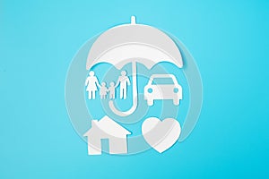 Umbrella cover family, home and Car shape paper on blue background. International day of families, Healthcare, wellness and