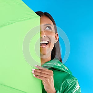 Umbrella, fun or happy woman in playful studio with raincoat, silly or happiness mockup. Goofy, face or excited female