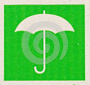 Umbrella image of fragile symbol on cardboard.