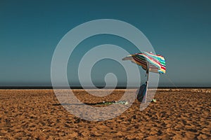 Umbrella left at a hot beach