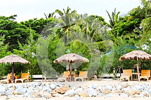 Umbrella and lounges at the shore.