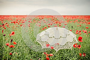 Umbrella in poppies field. Artistic interpretation.