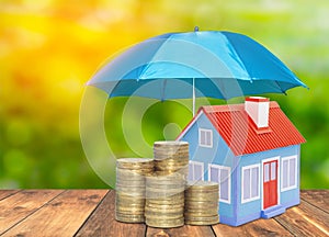 Umbrella protection House coins savings a business. Protection money insurance home concept