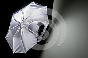 Umbrella reflector with flash gun photo