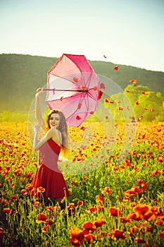 Umbrella sale. woman in field of poppy seed with umbrella