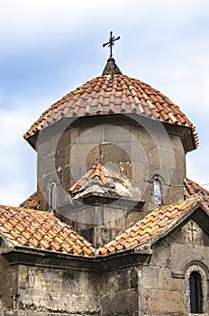 Umbrella-shaped roof,covered with red tiles and forged cross on the cross-shaped Church Karmravor